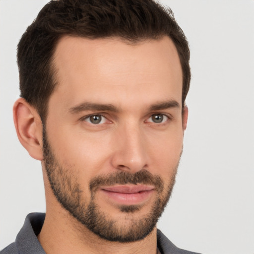 Joyful white young-adult male with short  brown hair and brown eyes