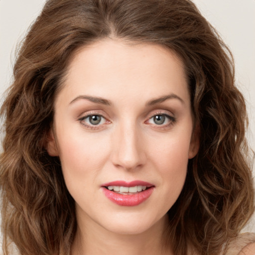 Joyful white young-adult female with long  brown hair and green eyes