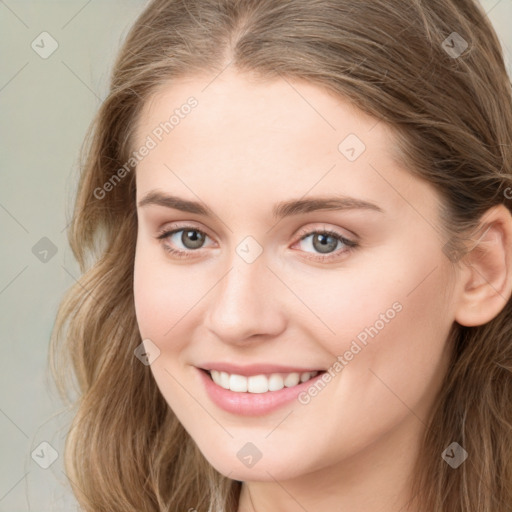 Joyful white young-adult female with long  brown hair and green eyes