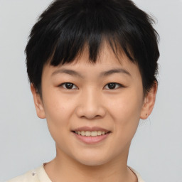 Joyful asian young-adult female with short  brown hair and brown eyes