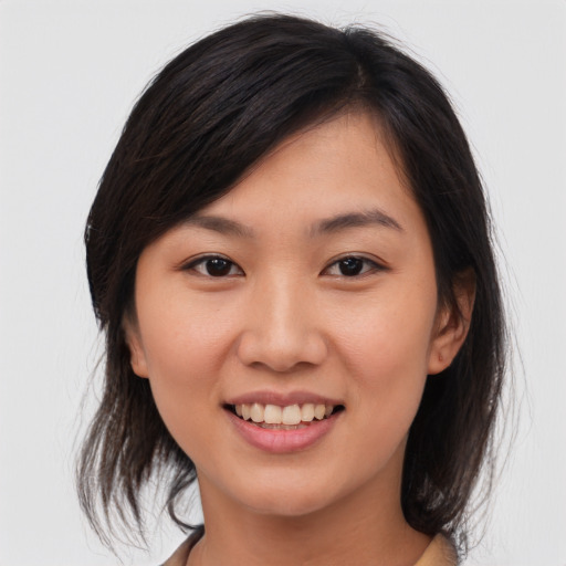 Joyful asian young-adult female with medium  brown hair and brown eyes