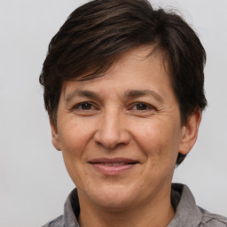 Joyful white adult female with short  brown hair and brown eyes