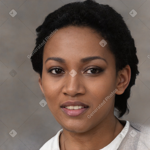 Joyful black young-adult female with short  black hair and brown eyes