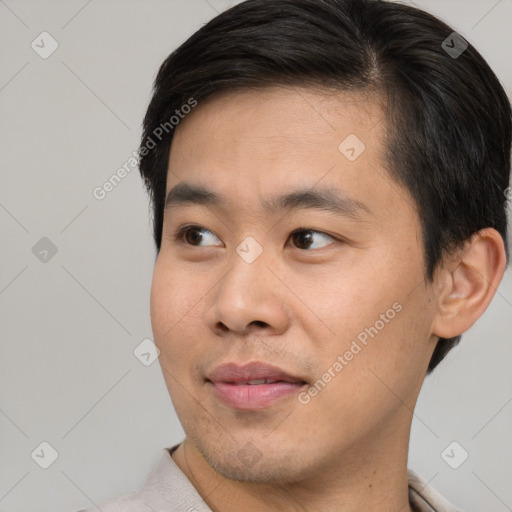 Joyful asian young-adult male with short  brown hair and brown eyes