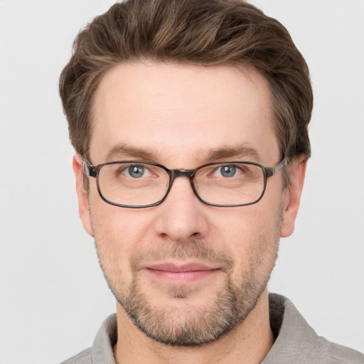 Joyful white adult male with short  brown hair and grey eyes