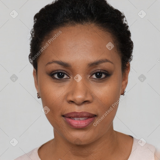 Joyful black young-adult female with short  black hair and brown eyes