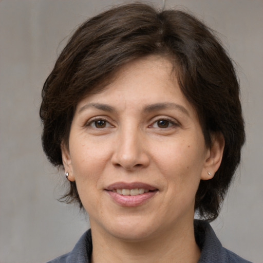Joyful white adult female with medium  brown hair and brown eyes