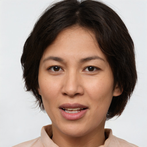 Joyful white adult female with medium  brown hair and brown eyes
