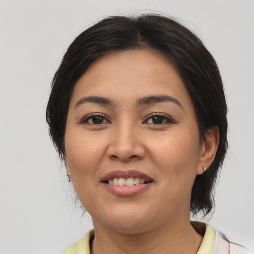 Joyful asian young-adult female with medium  brown hair and brown eyes