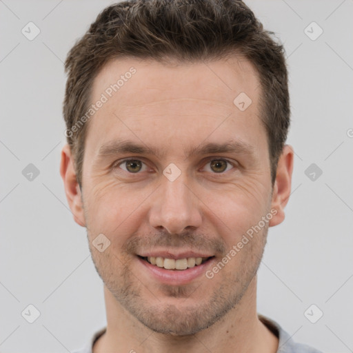 Joyful white adult male with short  brown hair and grey eyes