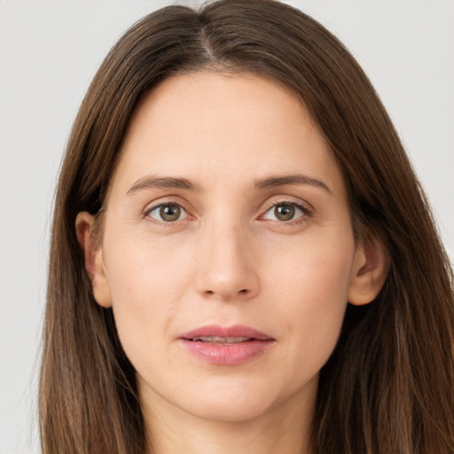 Joyful white young-adult female with long  brown hair and grey eyes