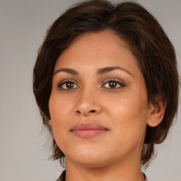 Joyful white young-adult female with medium  brown hair and brown eyes