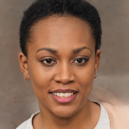 Joyful black young-adult female with short  brown hair and brown eyes