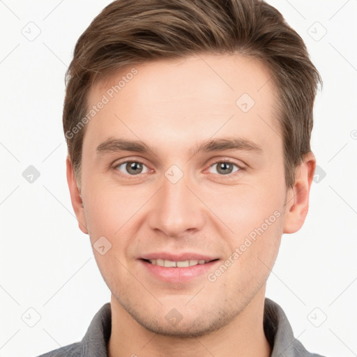 Joyful white young-adult male with short  brown hair and grey eyes