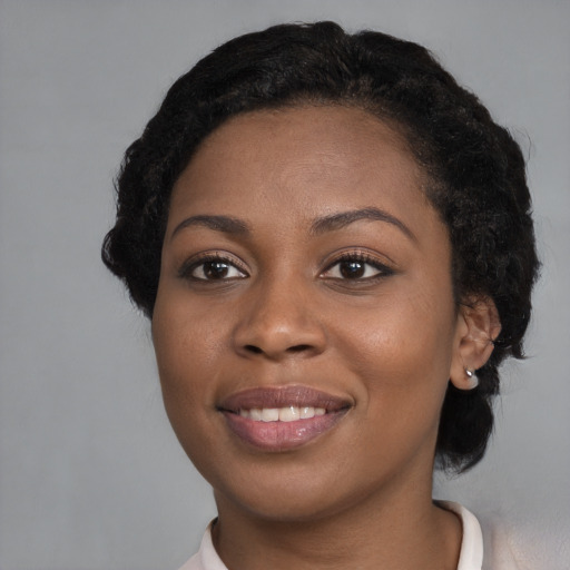 Joyful black young-adult female with medium  black hair and brown eyes