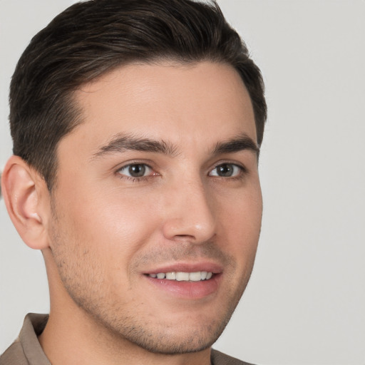 Joyful white young-adult male with short  brown hair and brown eyes