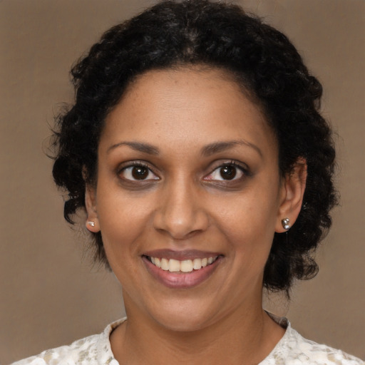 Joyful black young-adult female with medium  black hair and brown eyes