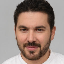 Joyful white adult male with short  brown hair and brown eyes