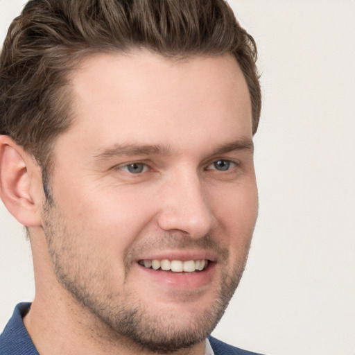 Joyful white young-adult male with short  brown hair and grey eyes