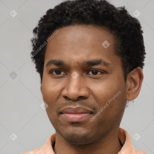 Joyful black young-adult male with short  brown hair and brown eyes