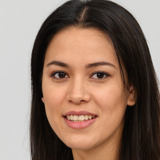 Joyful latino young-adult female with long  brown hair and brown eyes