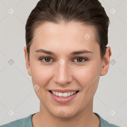 Joyful white young-adult female with short  brown hair and brown eyes