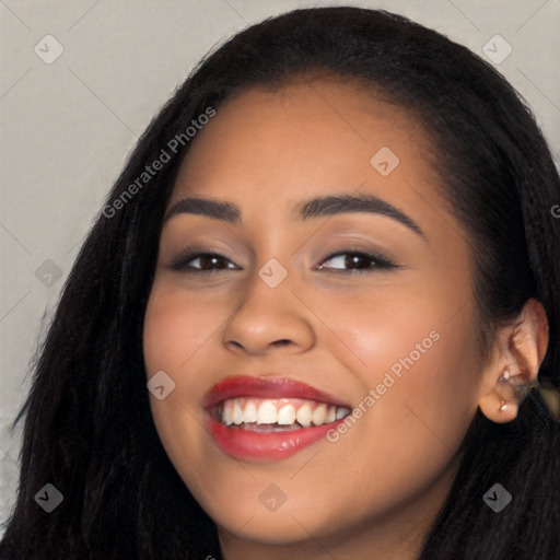 Joyful latino young-adult female with long  black hair and brown eyes