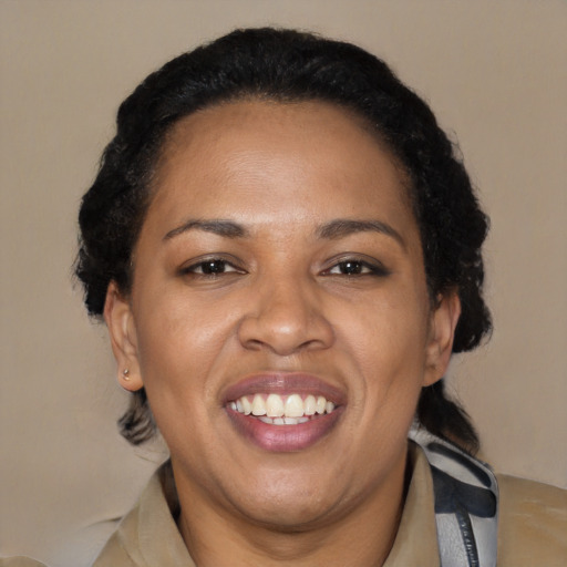 Joyful black adult female with short  black hair and brown eyes