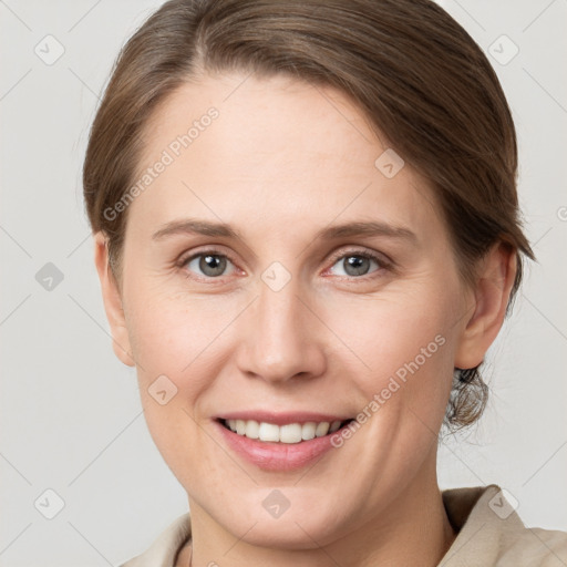 Joyful white young-adult female with medium  brown hair and grey eyes