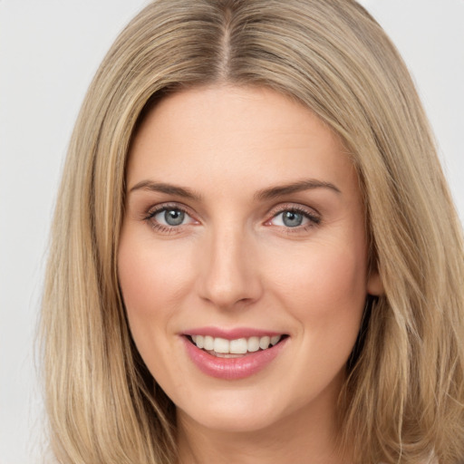 Joyful white young-adult female with long  brown hair and green eyes