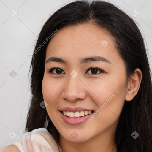 Joyful latino young-adult female with long  brown hair and brown eyes