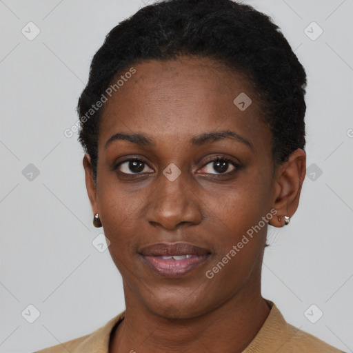 Joyful black young-adult female with short  black hair and brown eyes