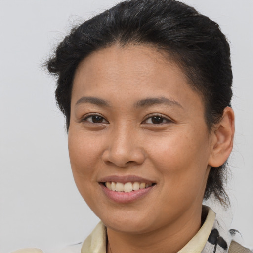Joyful asian young-adult female with short  brown hair and brown eyes