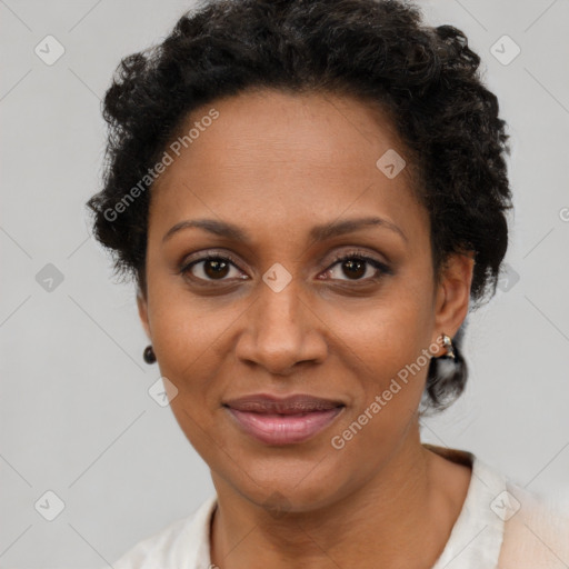 Joyful black adult female with short  brown hair and brown eyes