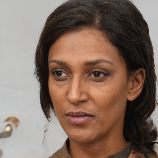 Joyful white adult female with medium  brown hair and brown eyes