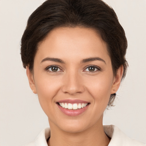 Joyful white young-adult female with medium  brown hair and brown eyes