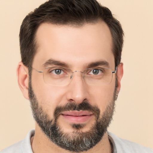 Joyful white adult male with short  brown hair and brown eyes