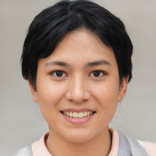 Joyful asian young-adult female with short  black hair and brown eyes