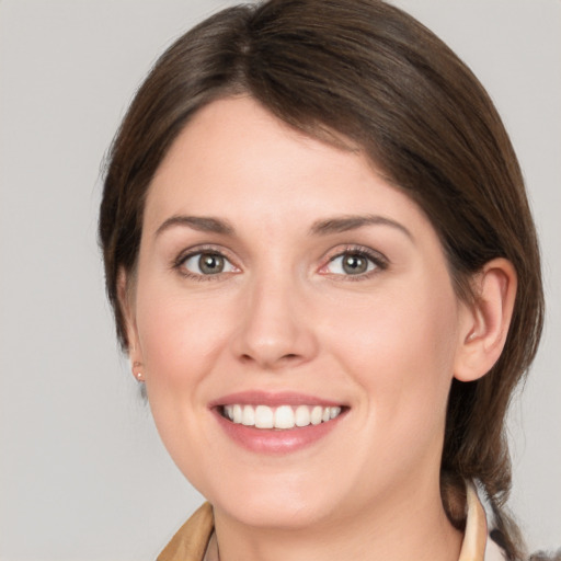 Joyful white young-adult female with medium  brown hair and brown eyes