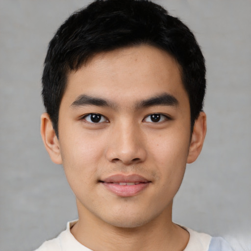 Joyful asian young-adult male with short  black hair and brown eyes
