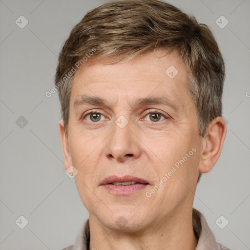 Joyful white adult male with short  brown hair and grey eyes