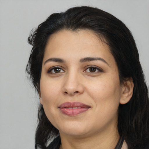 Joyful latino young-adult female with medium  black hair and brown eyes