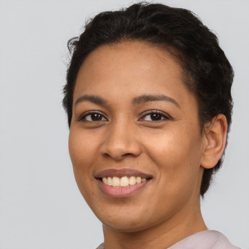 Joyful latino young-adult female with short  brown hair and brown eyes