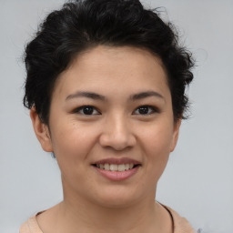 Joyful asian young-adult female with short  brown hair and brown eyes