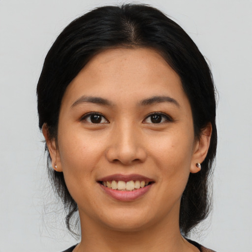 Joyful asian young-adult female with medium  black hair and brown eyes