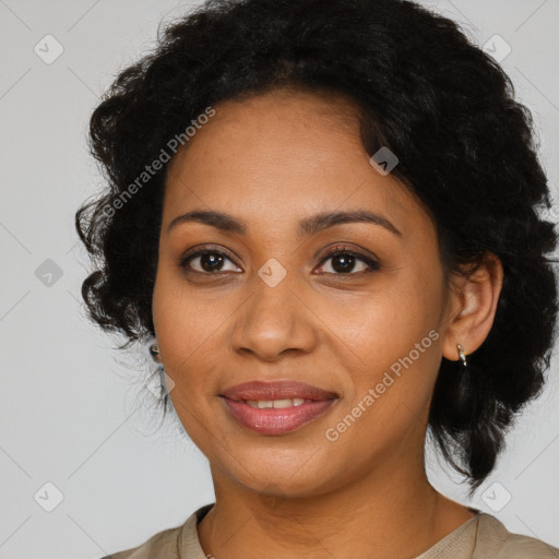 Joyful black young-adult female with long  brown hair and brown eyes