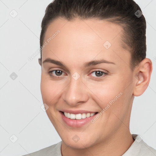 Joyful white young-adult female with short  brown hair and brown eyes