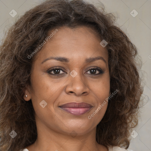 Joyful black adult female with long  brown hair and brown eyes