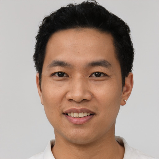Joyful asian young-adult male with short  black hair and brown eyes