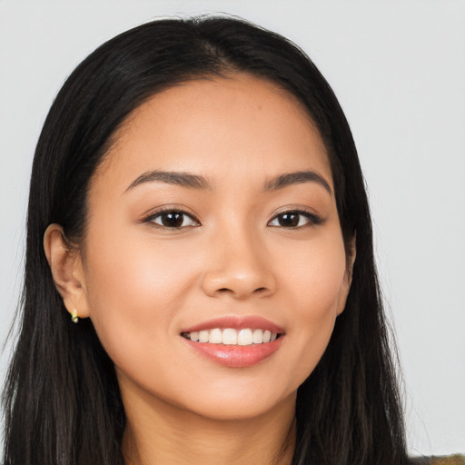 Joyful latino young-adult female with long  black hair and brown eyes